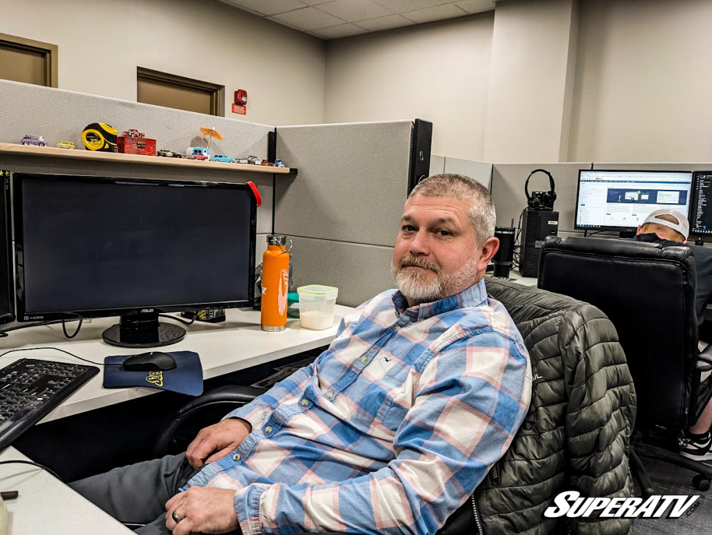 Travis sitting at his desk