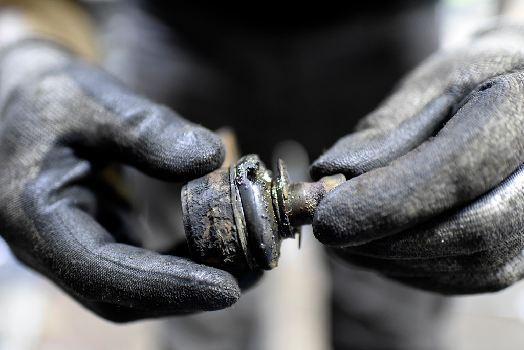 A Ball joint with a ruptured boot leaking grease.