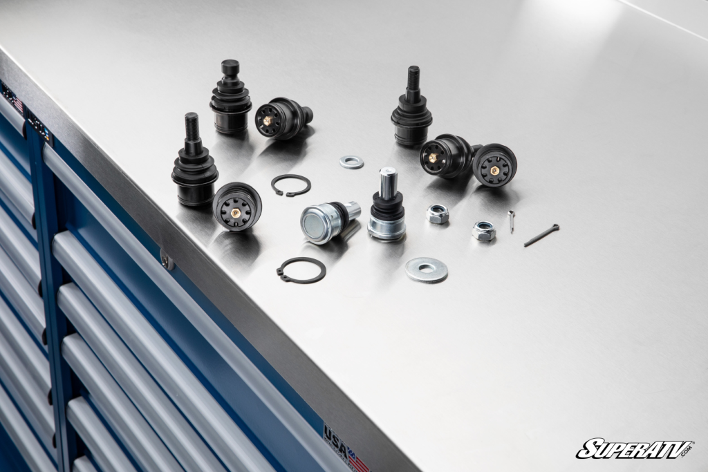 SuperATVs greaseable and adjustable utv ball joints next to a SuperATV OEM replacement ball joint.
