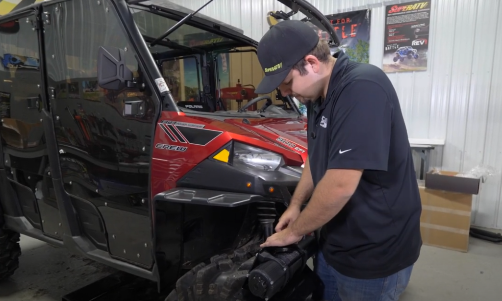 Braden installing the nut into the winch mounting plate.