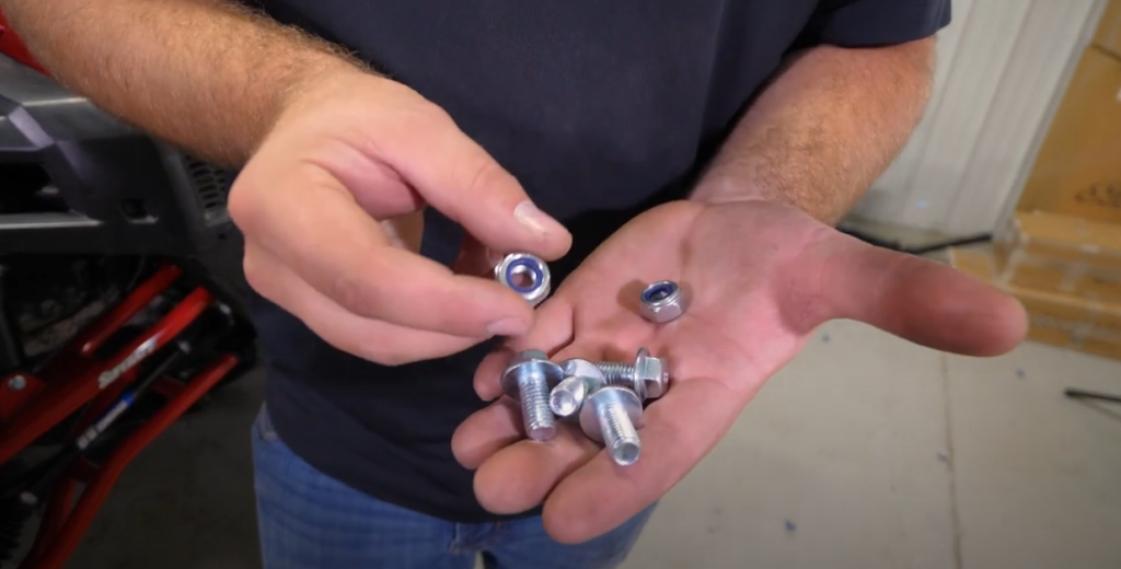 Braden with a handful of nuts and bolts provided in our winch kit.