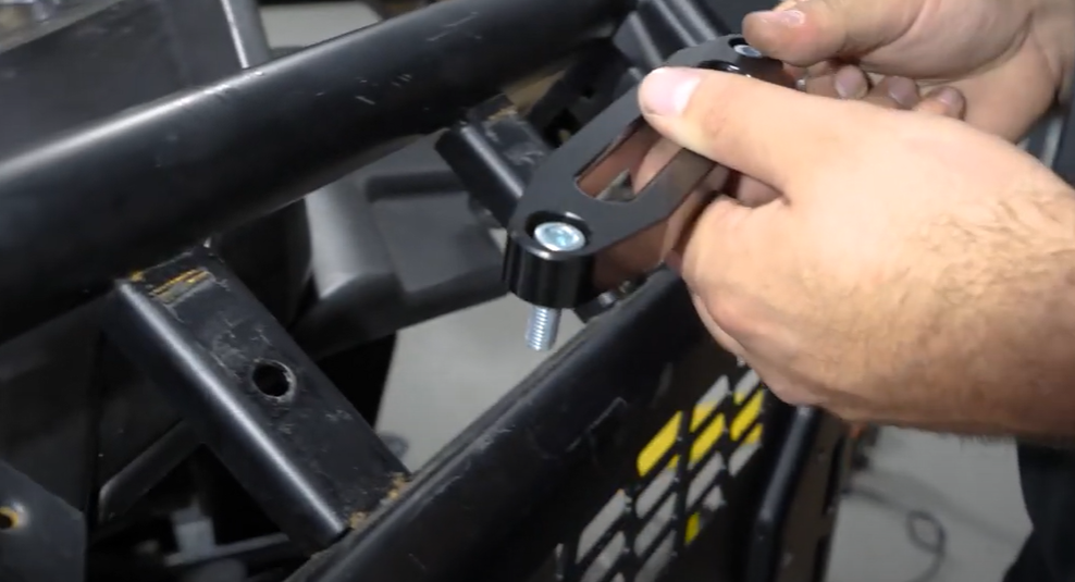 Braden securing the fairlead to the bumper with both hands.