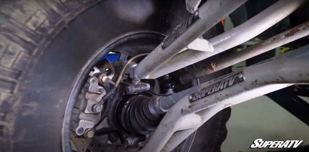 A view of the inside of a Polaris RZR spindle with A arms and axles still installed.