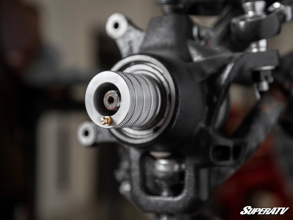 SuperATV's Polaris Wheel Bearing Greaser Tool affixed to a Polaris RZR 1000 wheel bearing while still installed in a spindle.