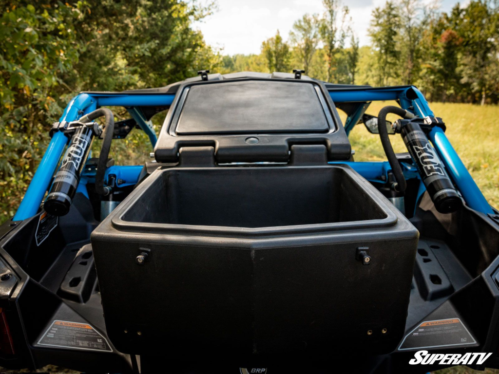 A cooler box installed in the back of a UTV with the lid flung wide open.