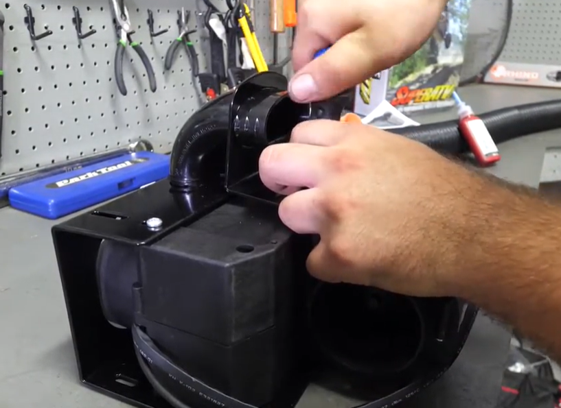A mechanic assembling the heater components. 