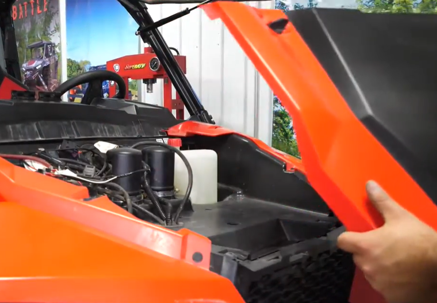 A mechanic removing the panels on his Polaris General 1000.