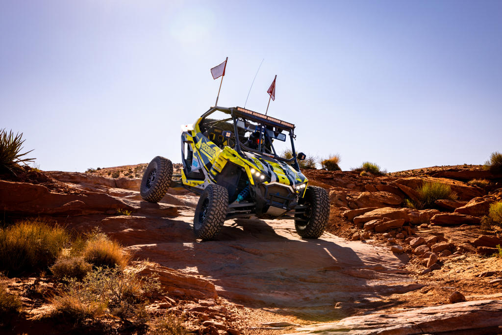 A UTV riding in the hot desert.