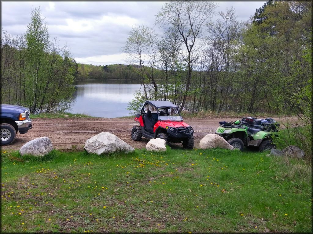 UTVs and ATVs parked at Spider Lake ATV Trail