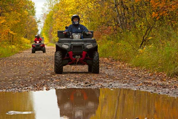 Riders driving through a puddle.