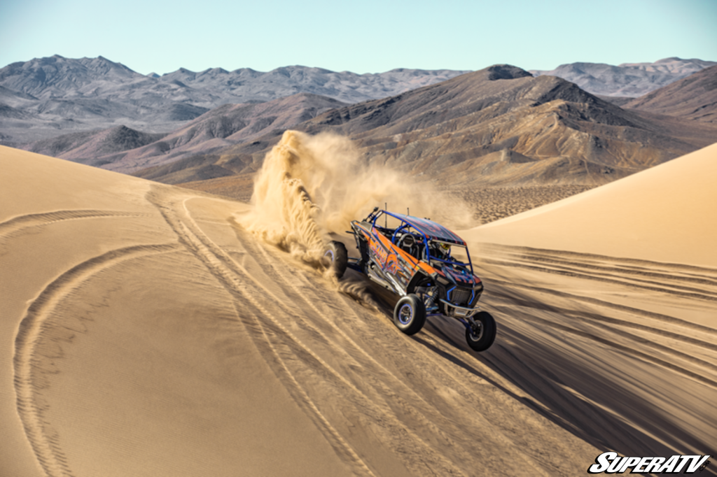 A UTV riding through the dunes.