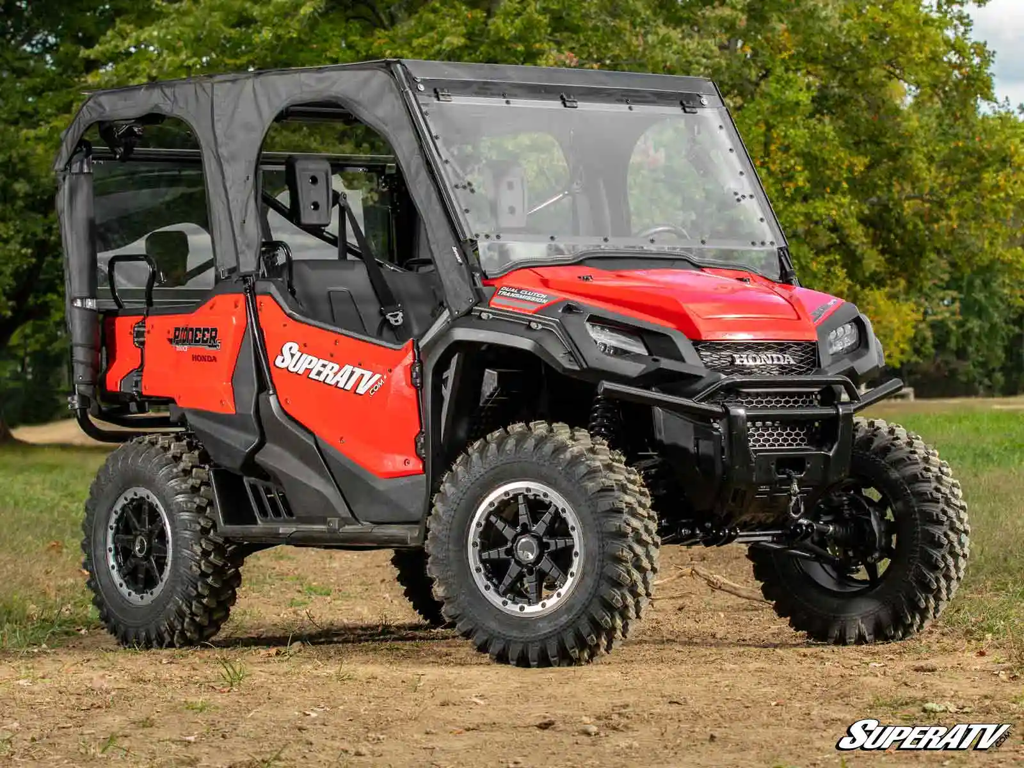 A Honda pioneer 1000-5 with a superatv flip winshield and cab enclosure