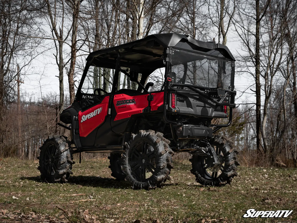A honda pioneer 1000-5 with GDP Portals, terminator max tires, and a superatv windshield and spare tire carrier