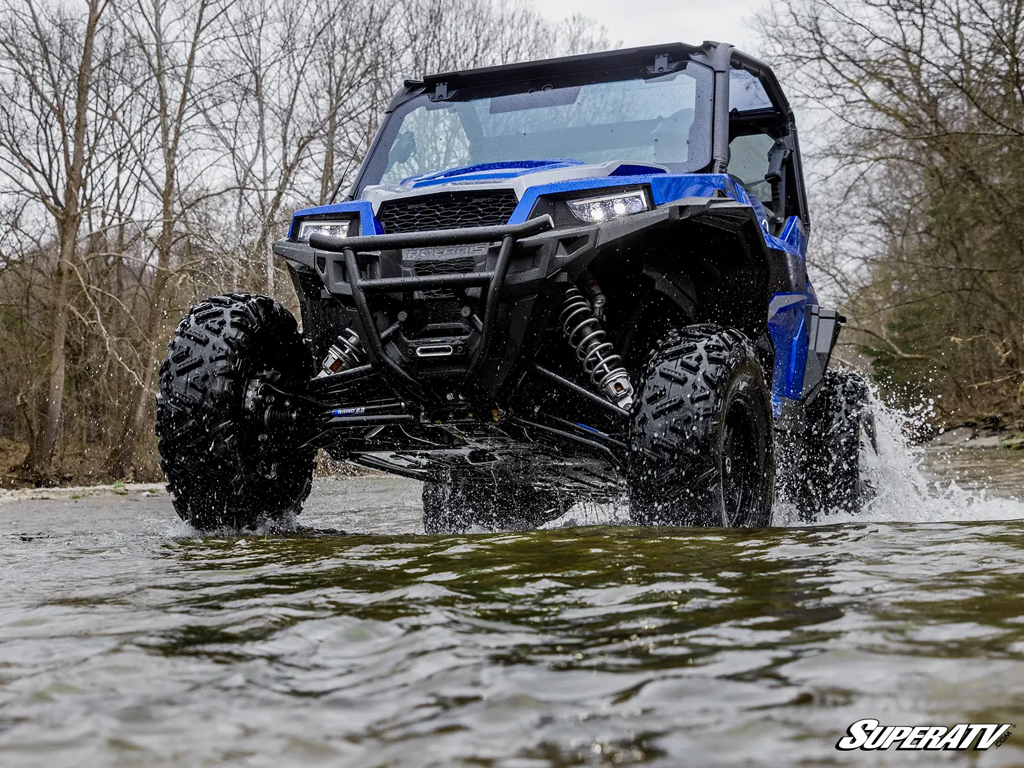 A Polaris UTV riding in a creek