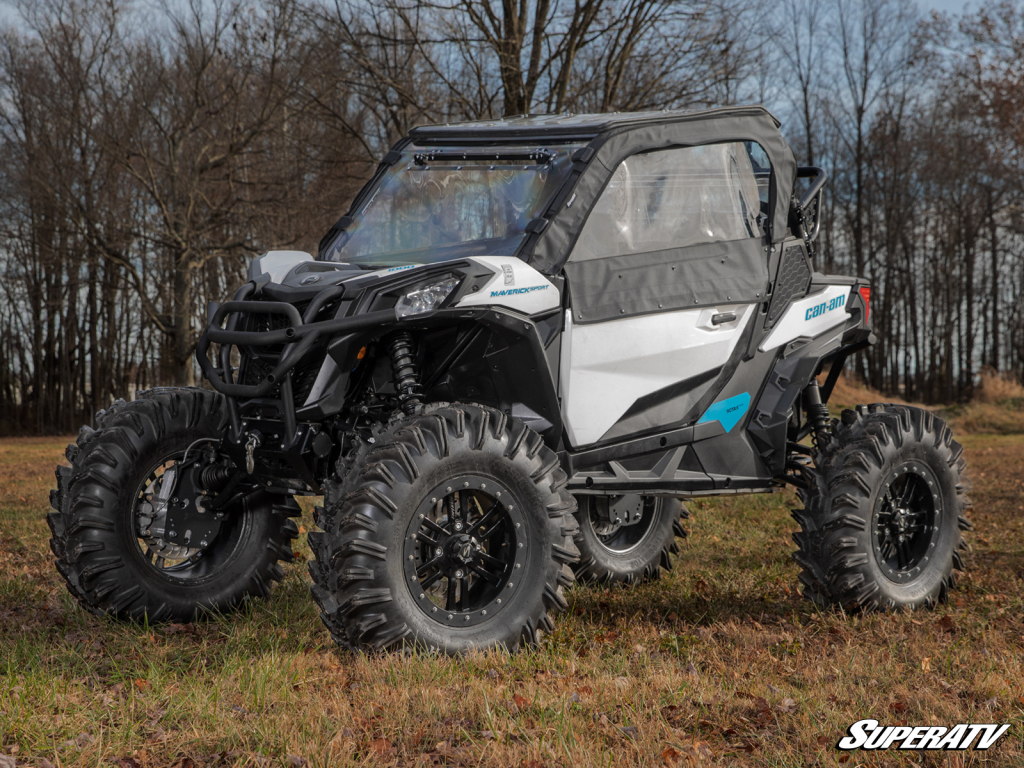 A lifted Can-Am Maverick Sport with a full cab enclosure.