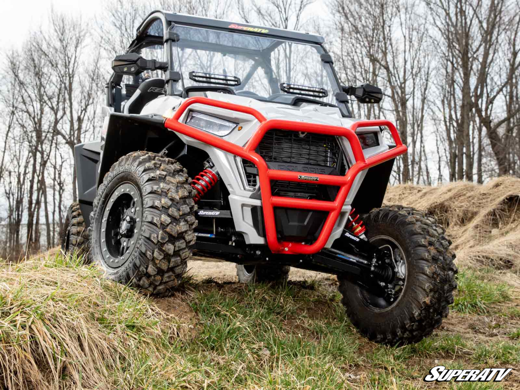 A Polaris RZR Trail parked at the top of an obstacle.
