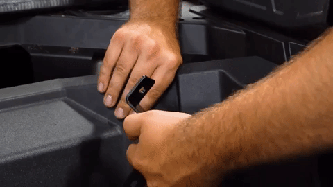 Brandon installs a black bracket over the OEM hole that he just removed the hardware from.
