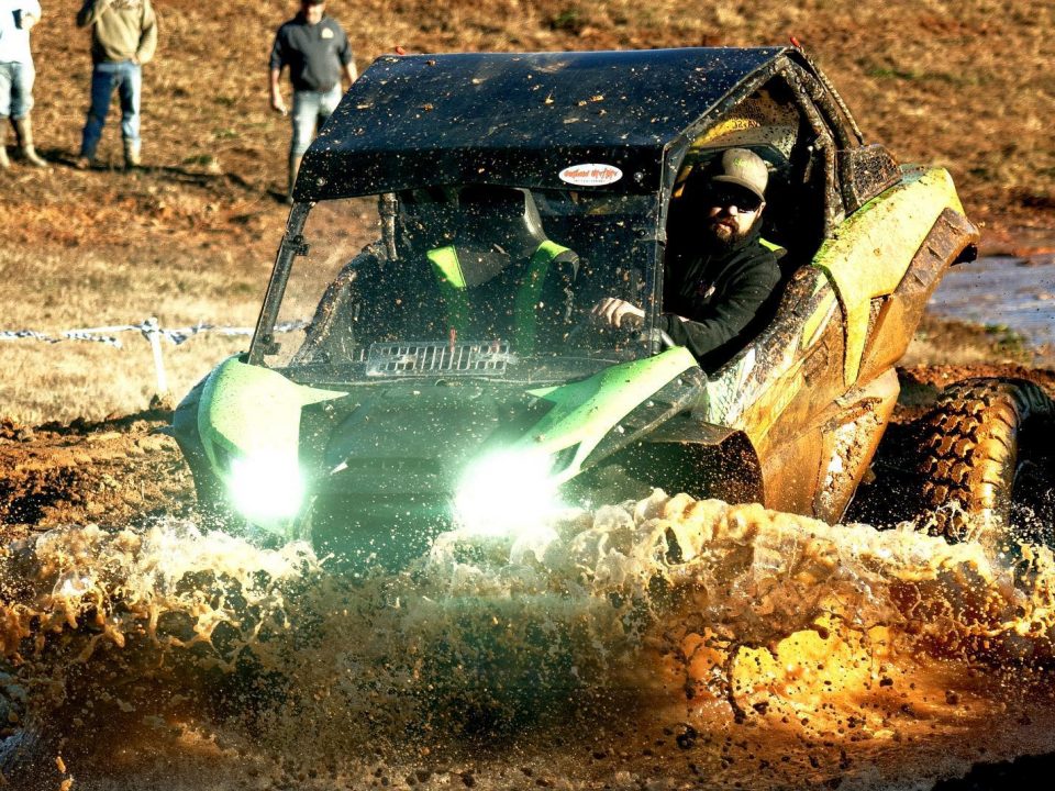 A UTV plowing through mud at Iron Mountain in Georgia