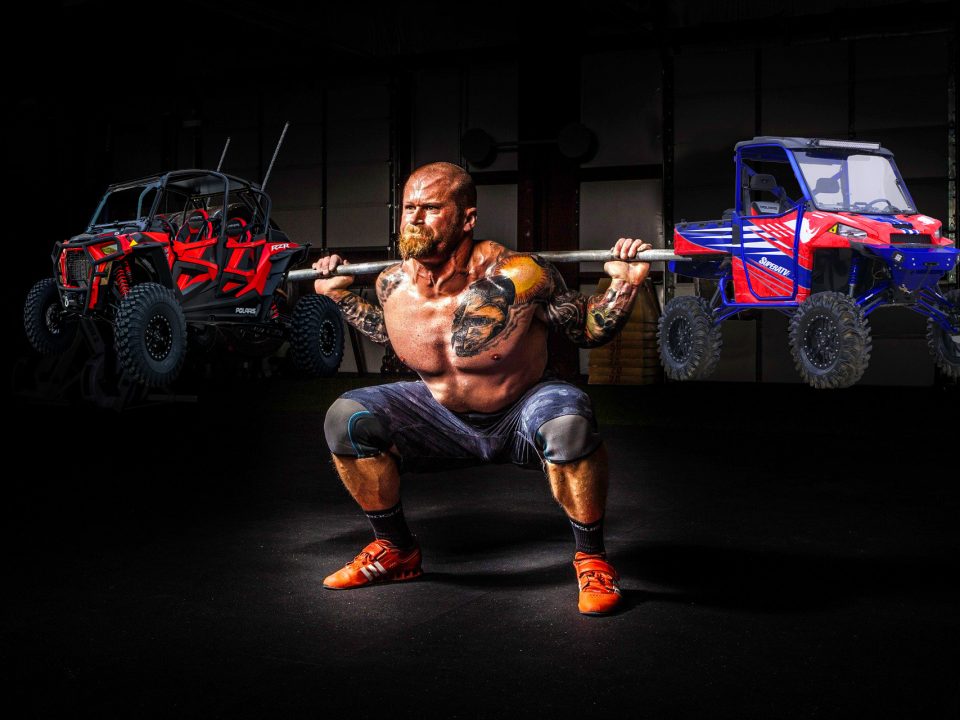 Weightlifter lifting two UTVs