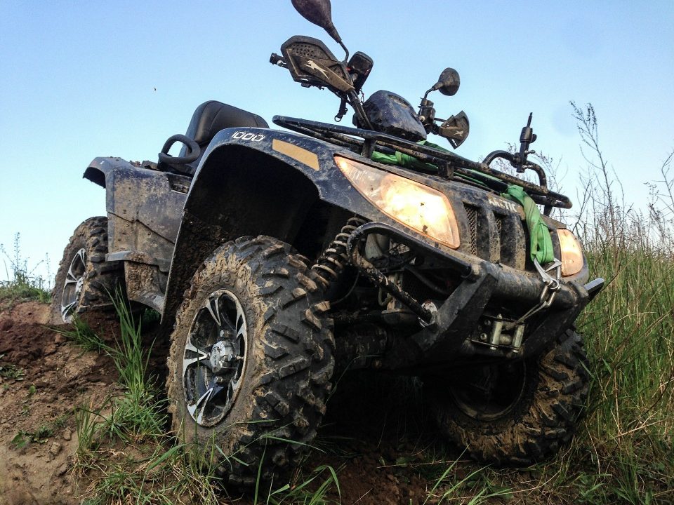 An Arctic Cat ATV with stock tires.