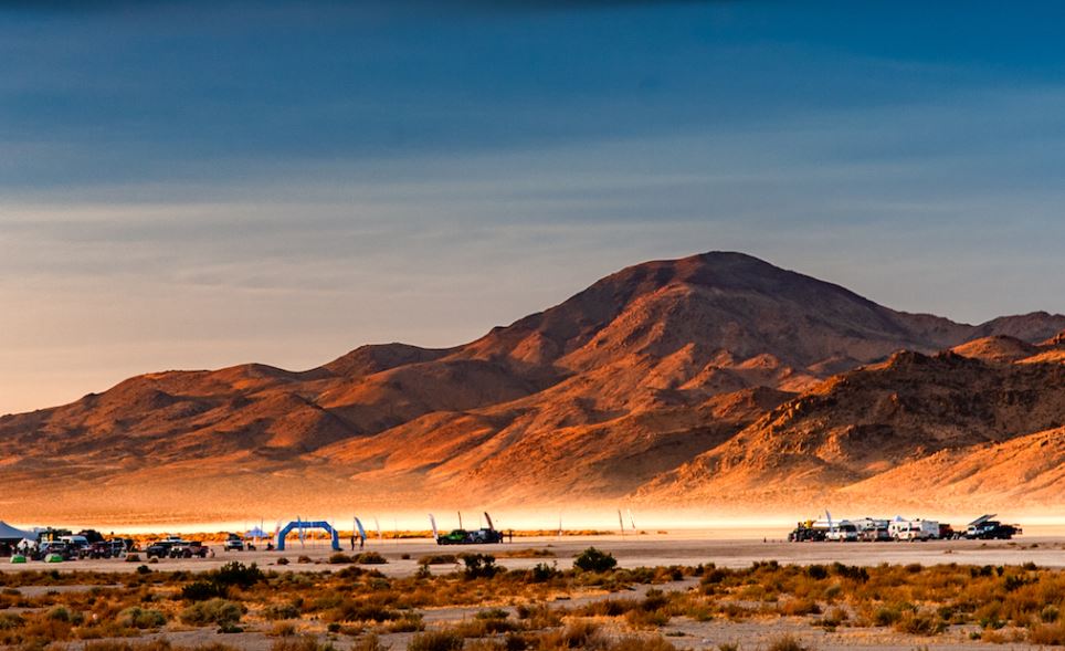 Off road vehicles in front of mountain in the desert