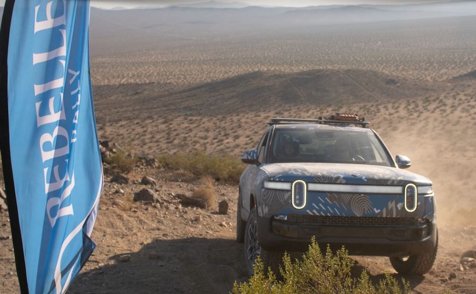Off Road Vehicle next to Rebelle Rally Flag in the desert