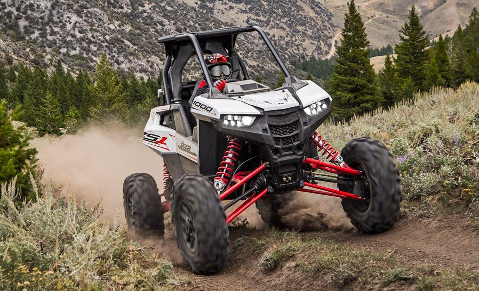 Polaris RZR RS1 coming up dirt trail in mountains