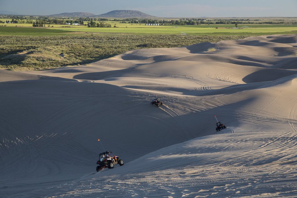 Machines riding through sand dunes