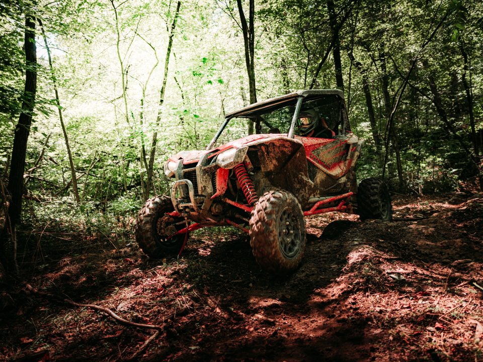A Honda Talon 1000R on a rough wooded trail