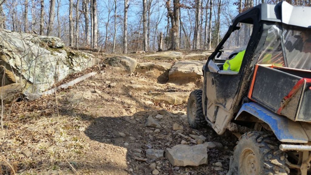 Machine riding up rocky hill