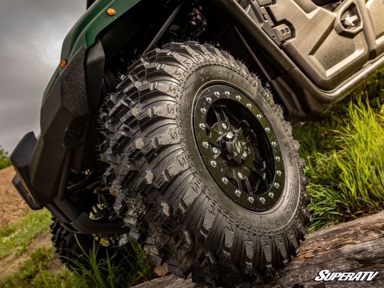 An angled shot of all-terrain tires on a Kawasaki Mule.
